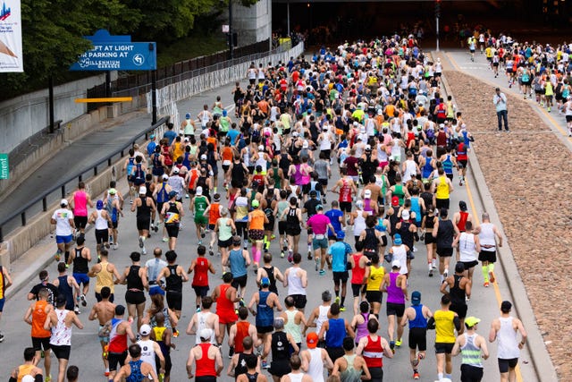 Large group of runners participating in a marathon on a city street