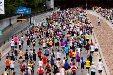 Large group of runners participating in a marathon on a city street