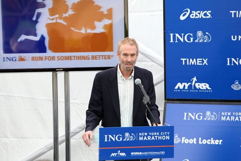 amby burfoot speaks at a podium