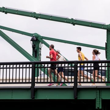 a group of people 45ts201 running on a bridge