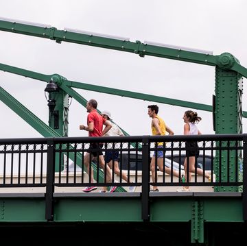 a group of people running 45ts201 on a bridge