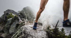 running on mountain ridge in puddle