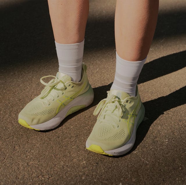 a pair of legs wearing green running shoes a pair of legs wearing green running shoes