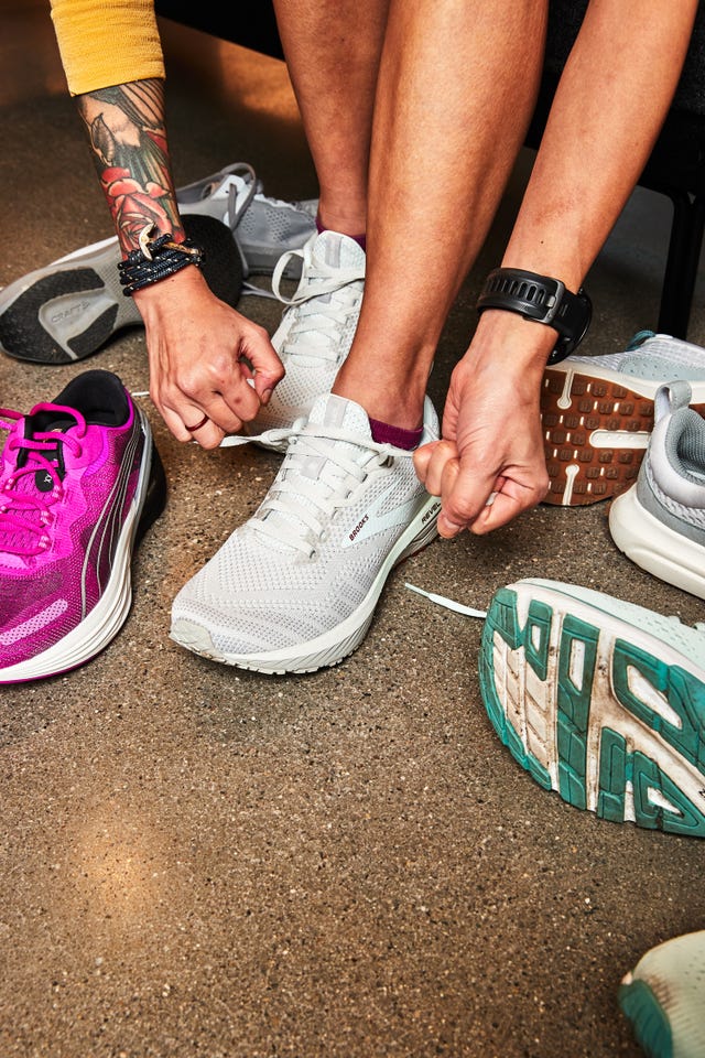 person tying shoelaces in a shoe fitting area