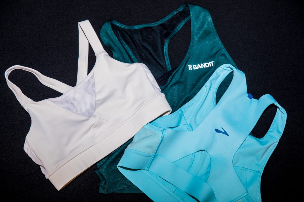 three sports bras in varying colors laid out on a dark background