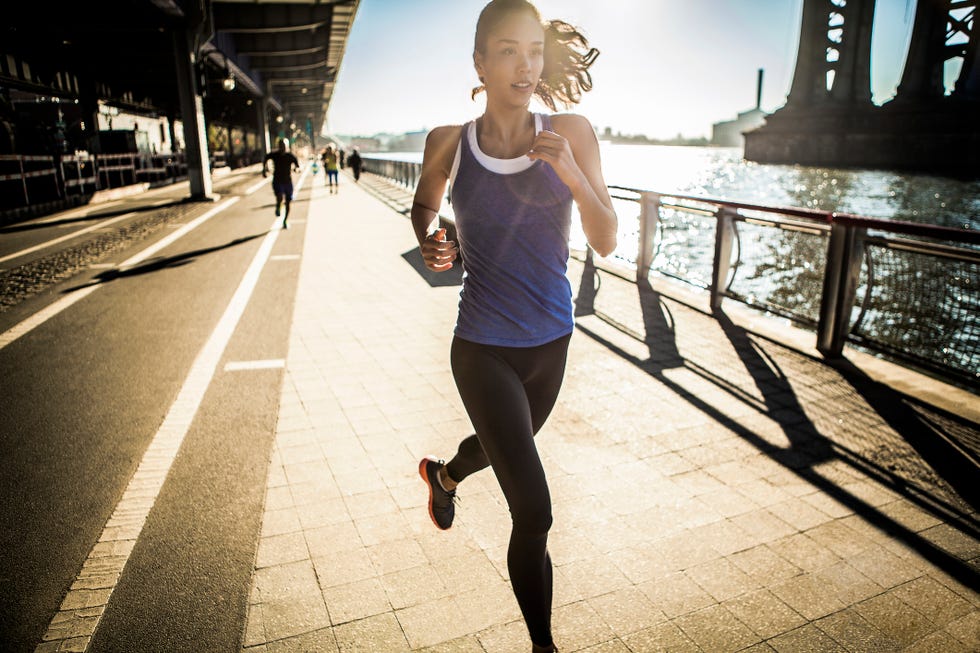 Running team, running under bridge, New York, USA