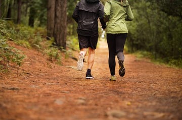 running together on forest trail