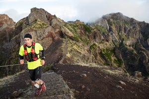 trail runner on a highland mountain trail, madeira, portugal