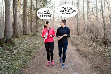 two women walking on a path in a wood