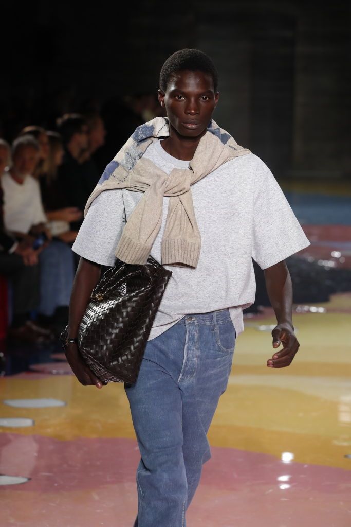 a model carries a bottega bag in a roundup of spring 2023 fashion trends worth shopping