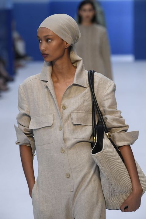 a model carries a max mara bag in a guide to summer 2023 bag trends