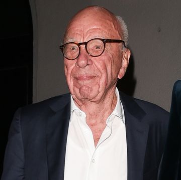 rupert murdoch wears a suit jacket, a white collared shirt that is unbuttoned at the neck and tortoise brown glasses