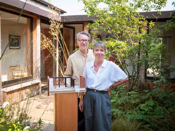 russell pinch and oona bannon of pinch design in their devon home with a model of their home