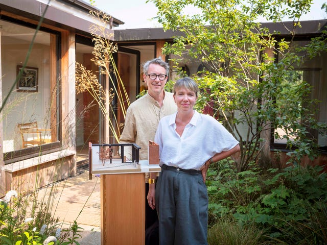 russell pinch and oona bannon of pinch design in their devon home with a model of their home