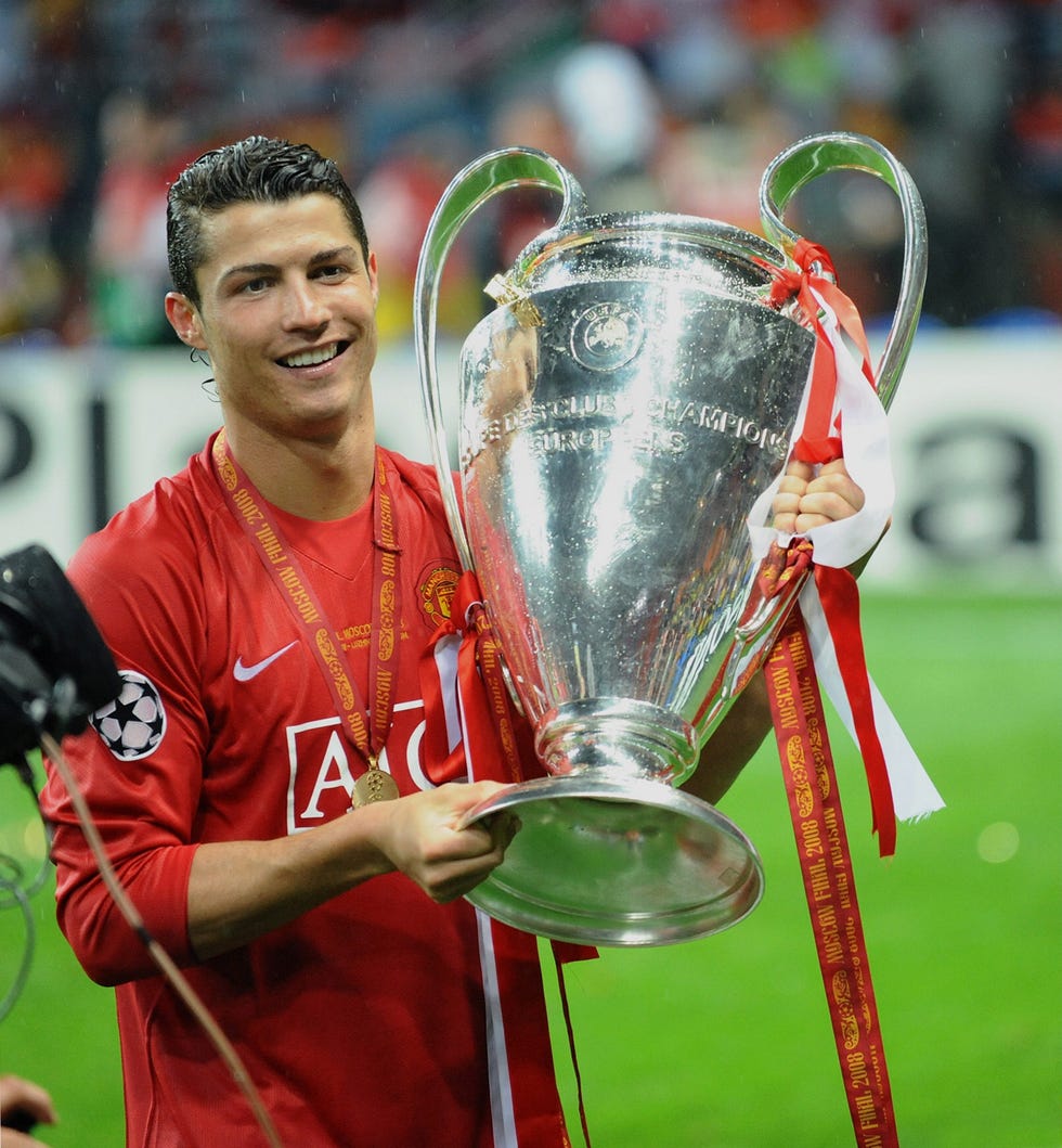 cristiano ronaldo holding a large trophy and smiling