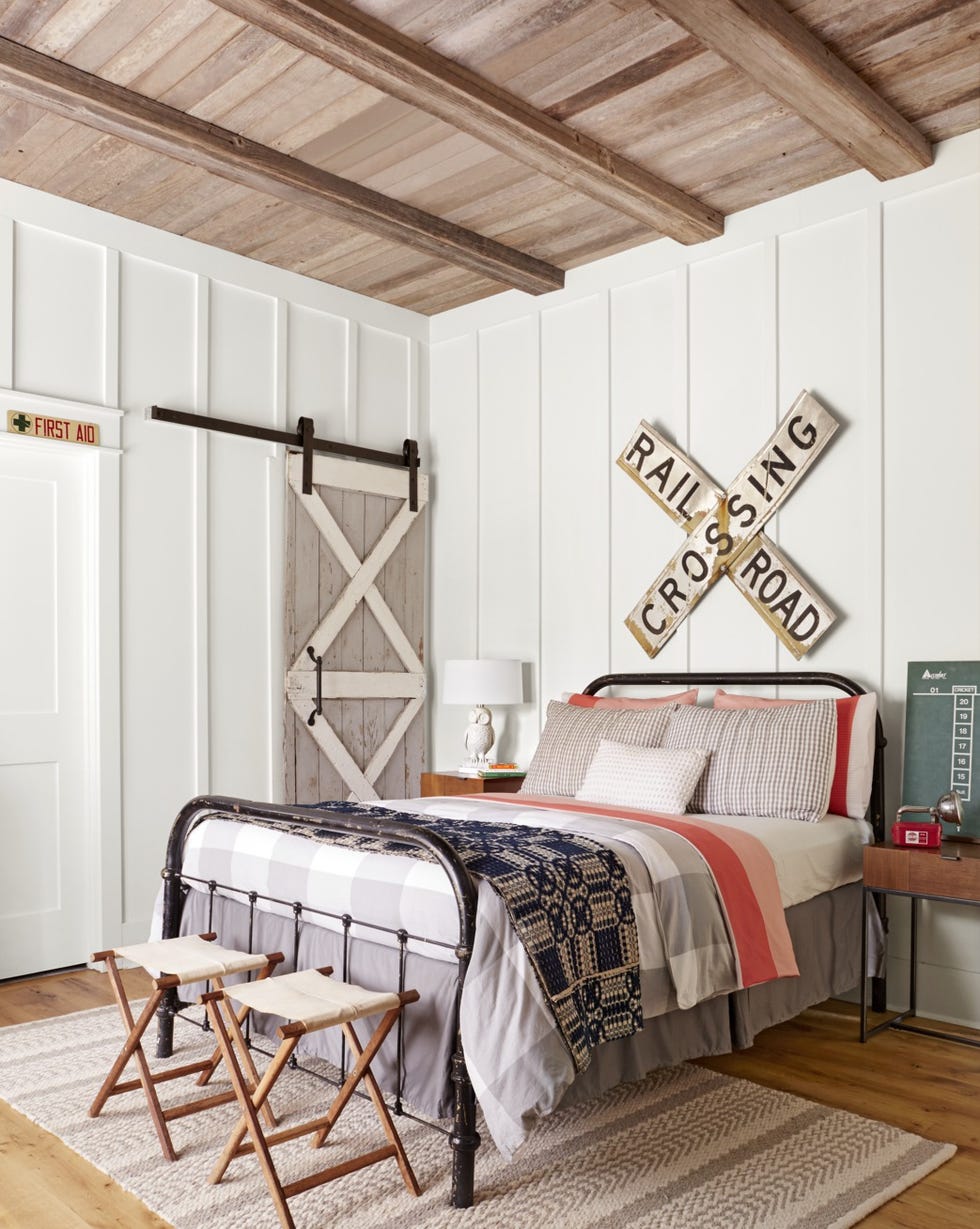 a rustic bedroom with a railroad sign