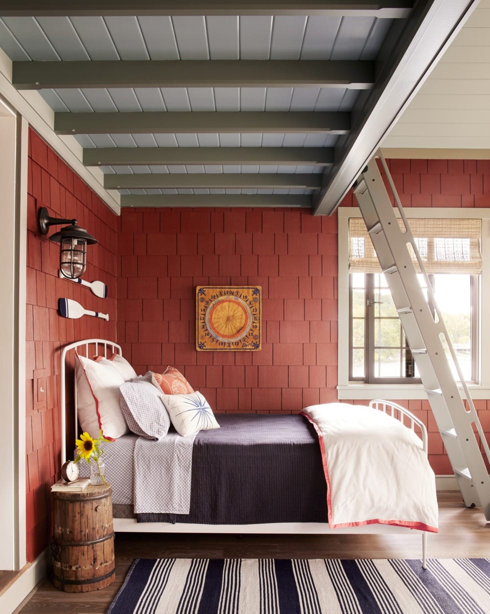 a rustic bedroom design with red shingle walls