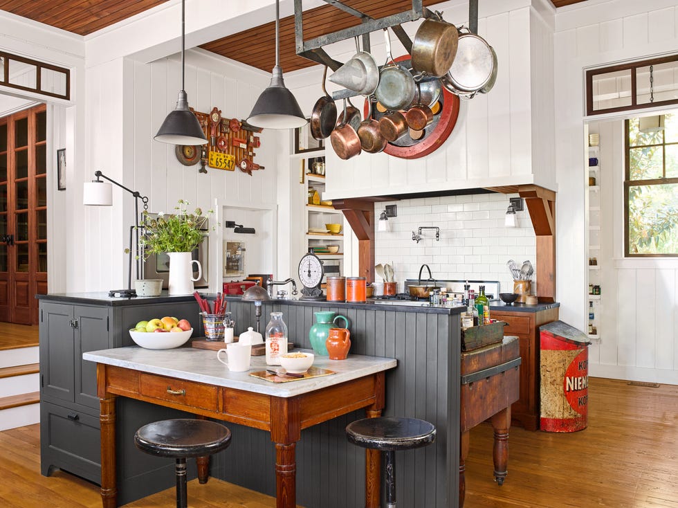 a farmhouse kitchen with a pot rack above