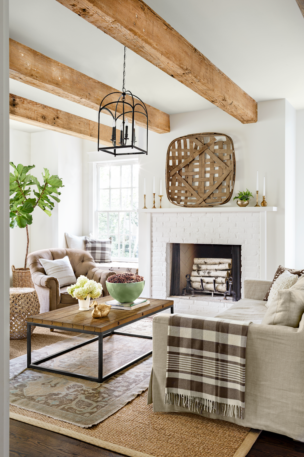 rustic neutral living room with layers of texture like rugs and velvet and baskets