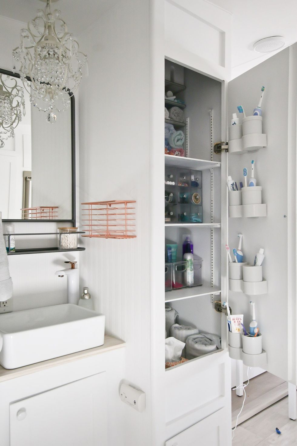 a white cabinet with a mirror and a sink