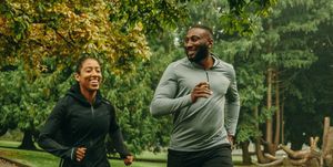 two runners smiling running on a path