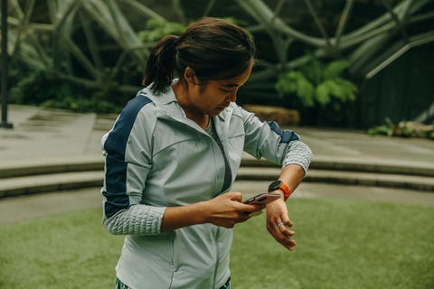 person checking their smartphone while wearing athletic gear