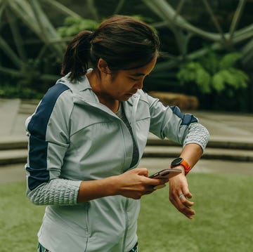 RWX person checking their smartphone while wearing athletic gear