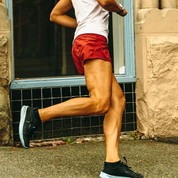 person running on a city sidewalk in athletic wear person running on a city sidewalk in athletic wear