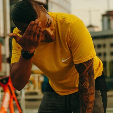Person in a yellow shirt covering their face with one hand person in a yellow shirt covering their face with one hand
