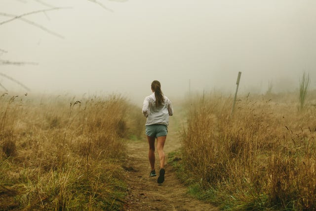 a woman runs without worrying about metrics or her weight