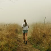 a woman runs without worrying about metrics or her weight