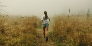 a woman runs without worrying about metrics or her weight