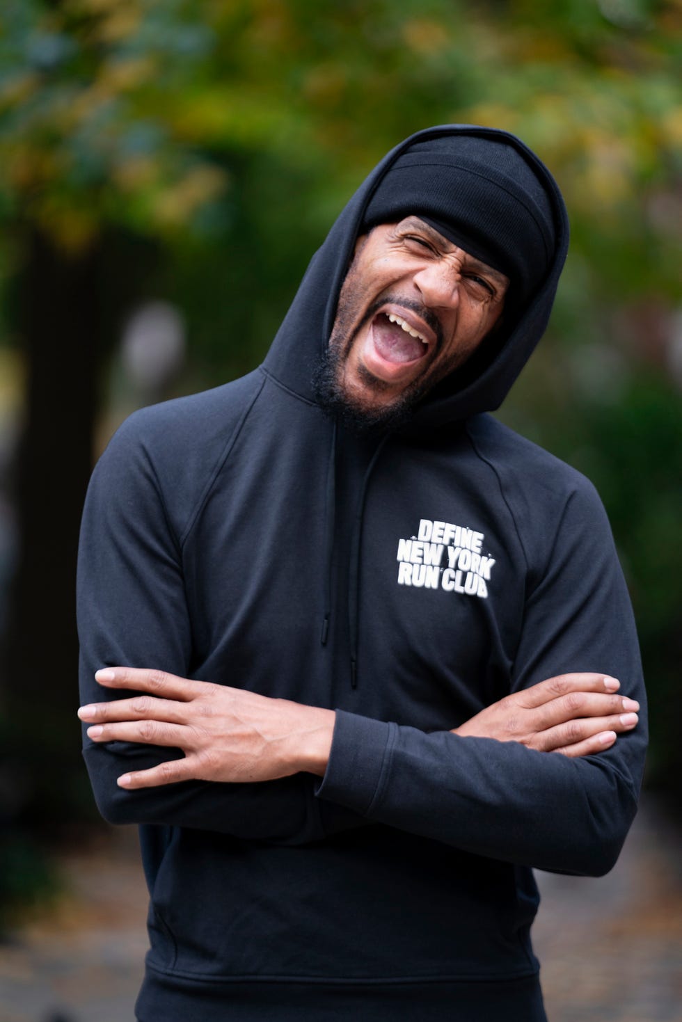 a man laughing while posing for a portrait