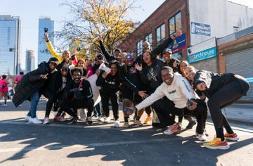 a group of people cheer as they pose for a group photo