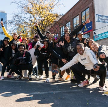 a group of people cheer as they pose for a group photo a group of people cheer as they pose for a group photo