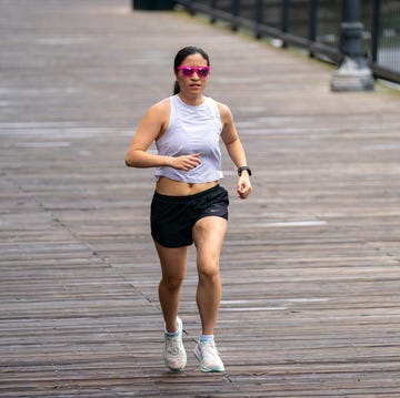 a person jogging on a wooden pathway near water a person jogging on a wooden pathway near water