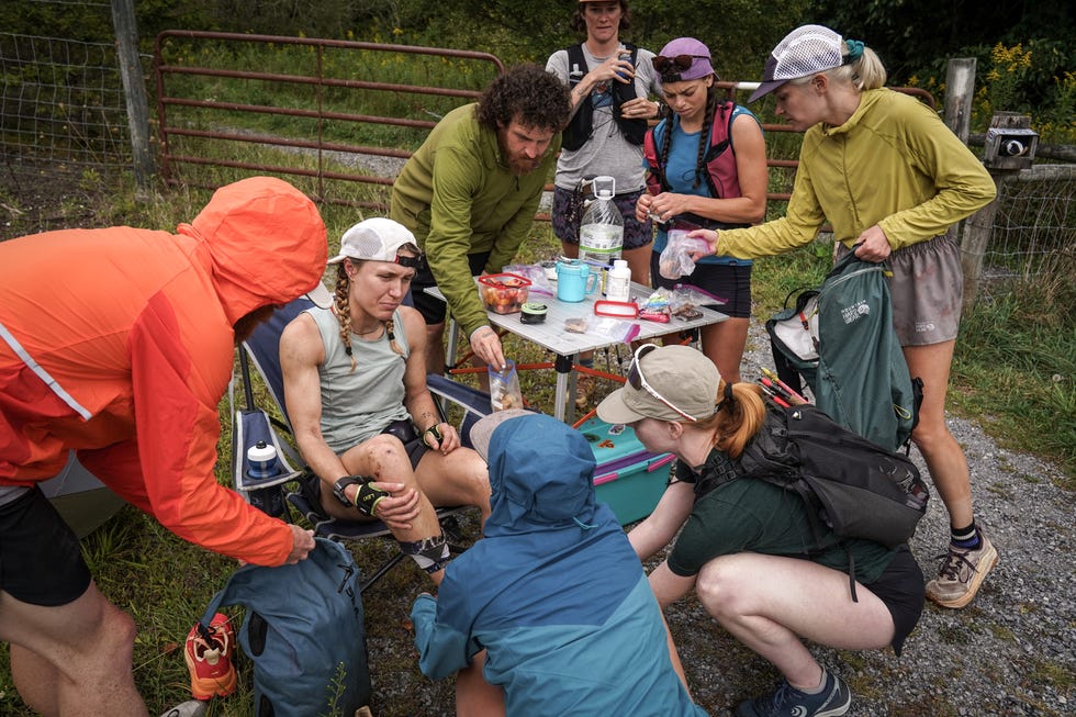 a runner is supported by a crew