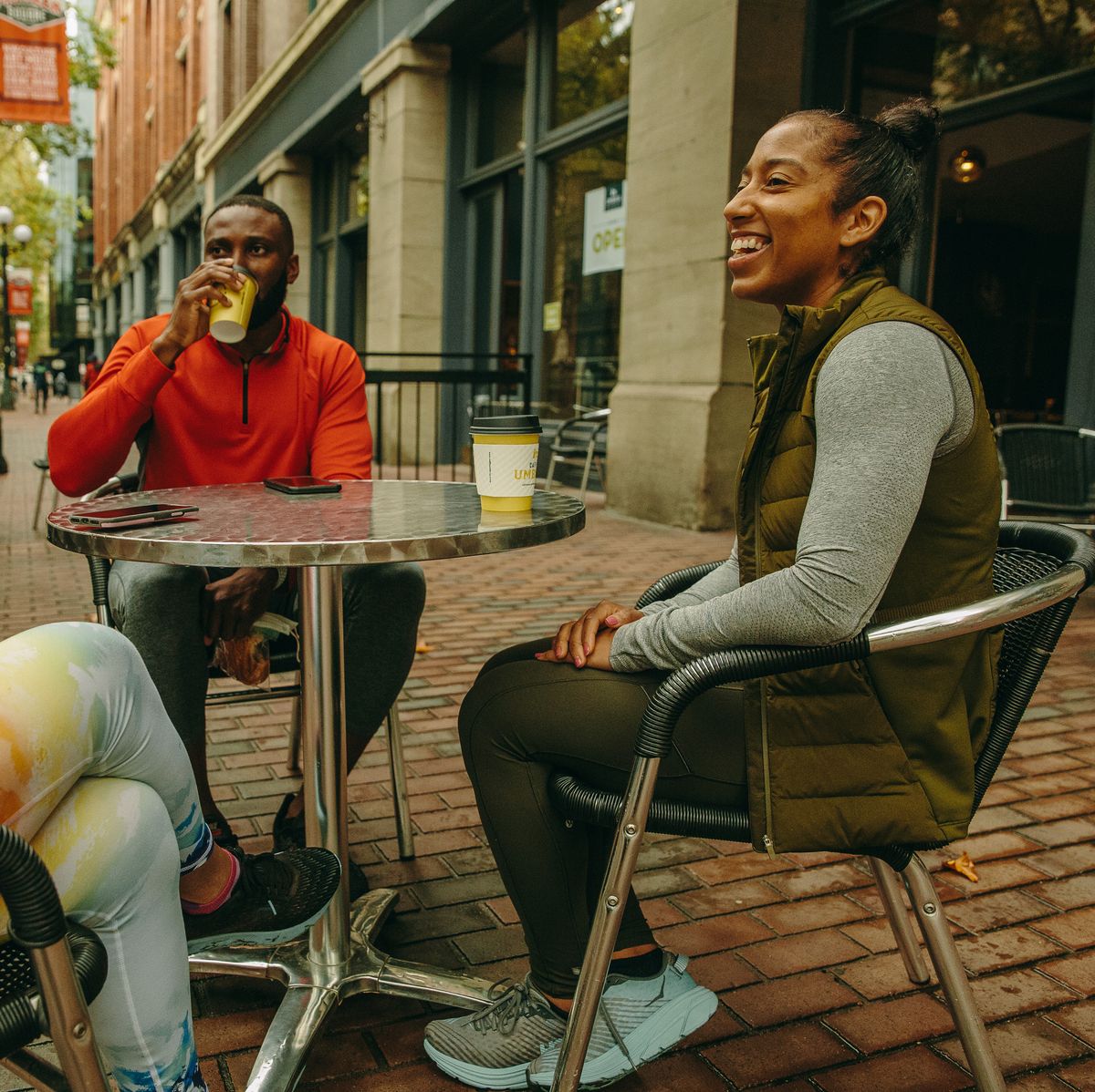 three runners drinking coffee after a run
