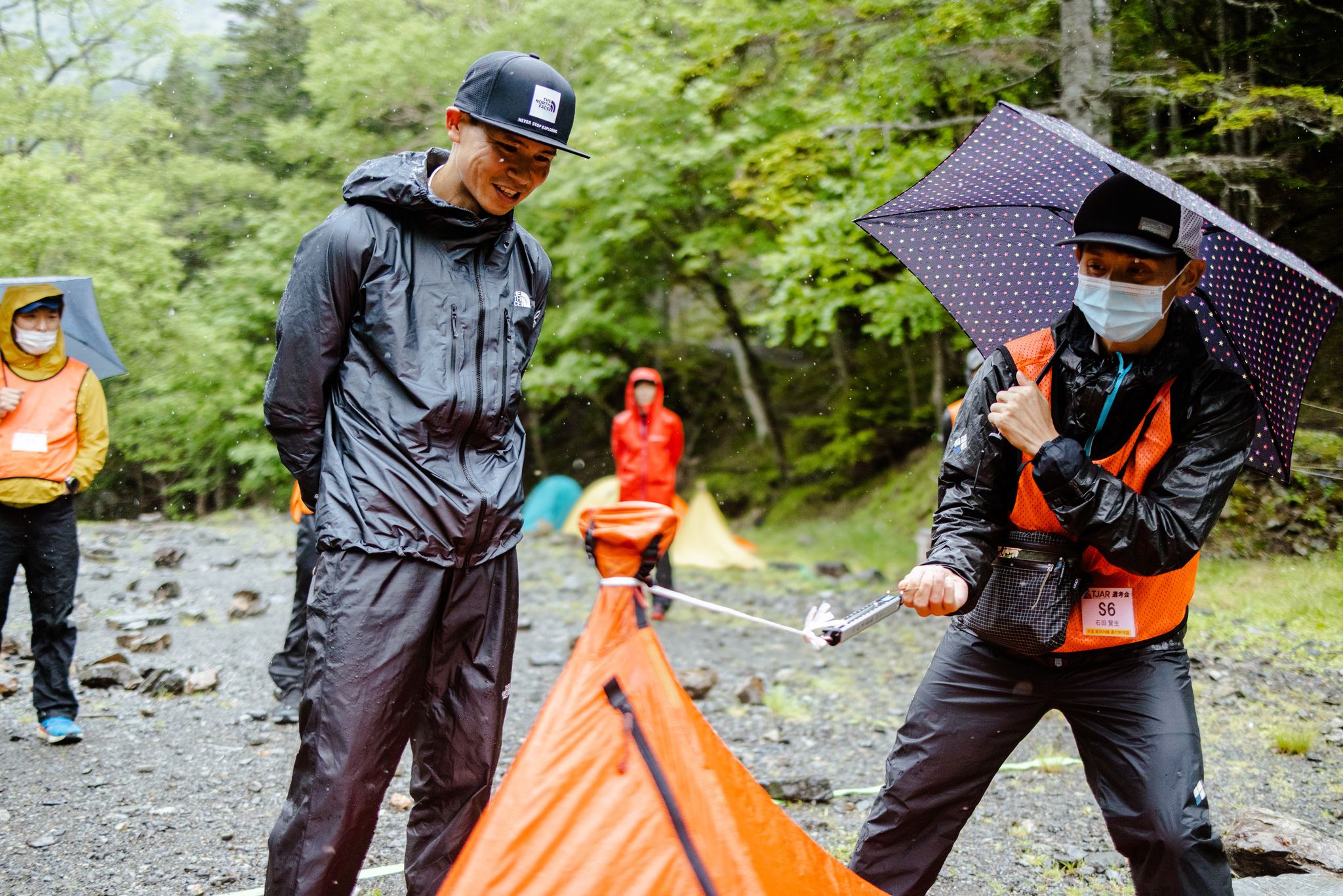takashi doi looks on a trans japan ultra official tests his tent