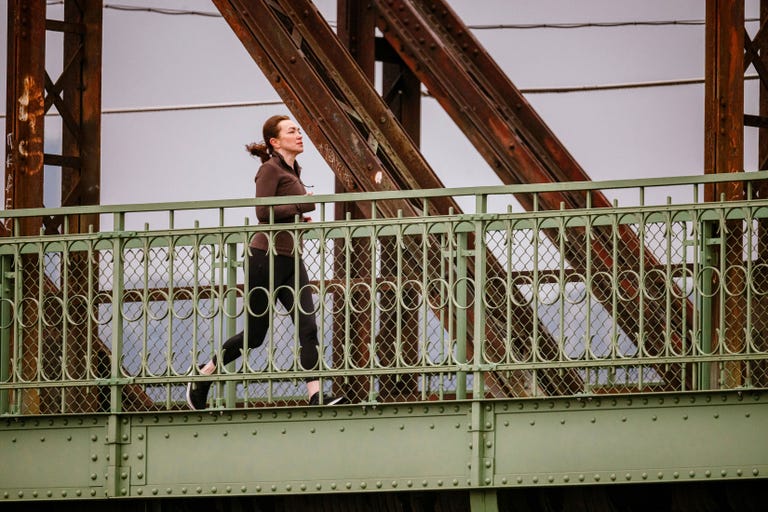 person jogging on a bridge
