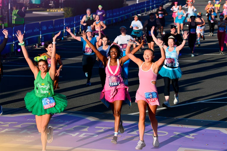 runners celebrating close to the finish line at the 2025 disney princess half marathon