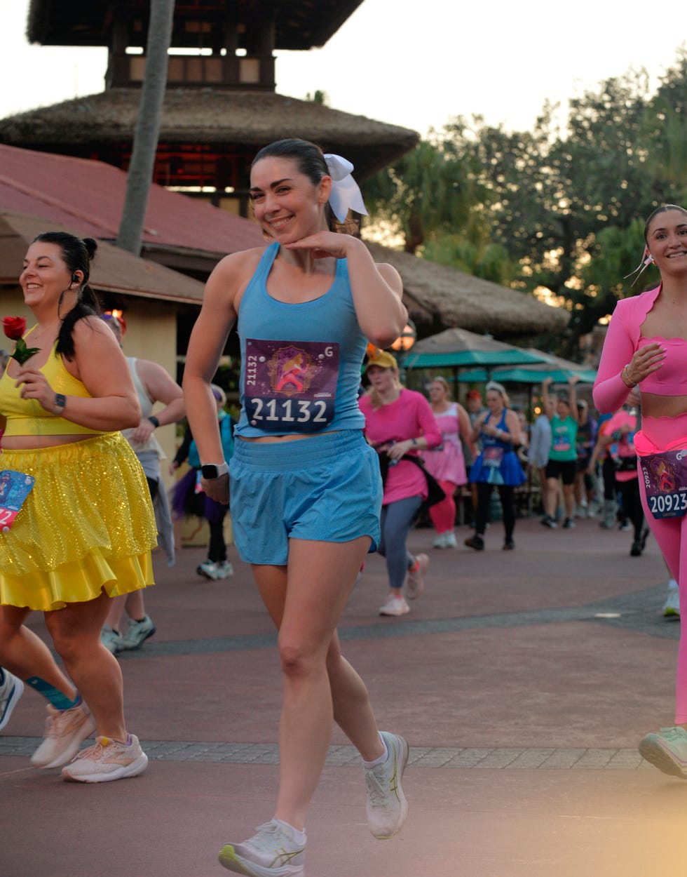 Participants in a colorful group run event wearing varied athletic outfits