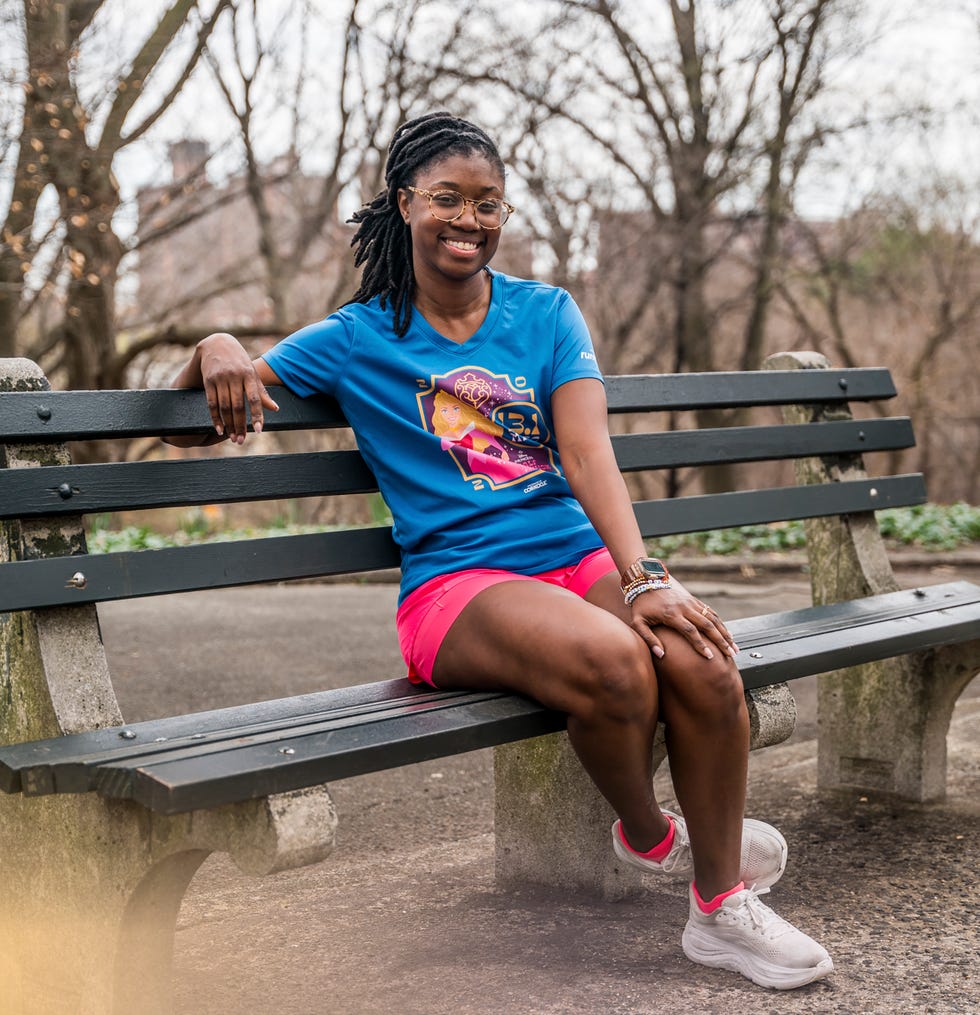 Person sitting on a park bench wearing sports attire