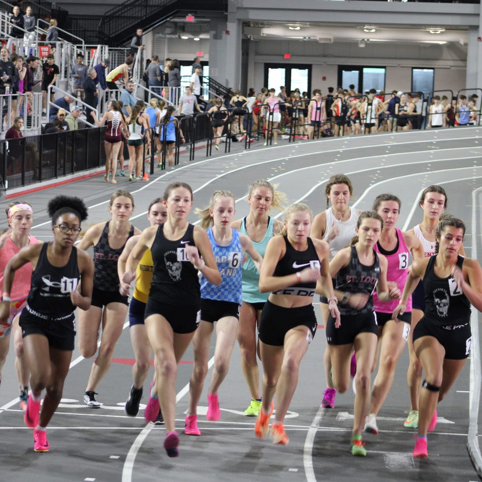 a group of people running on a track