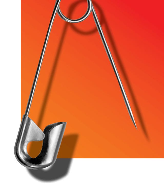 metal safety pin against a gradient background