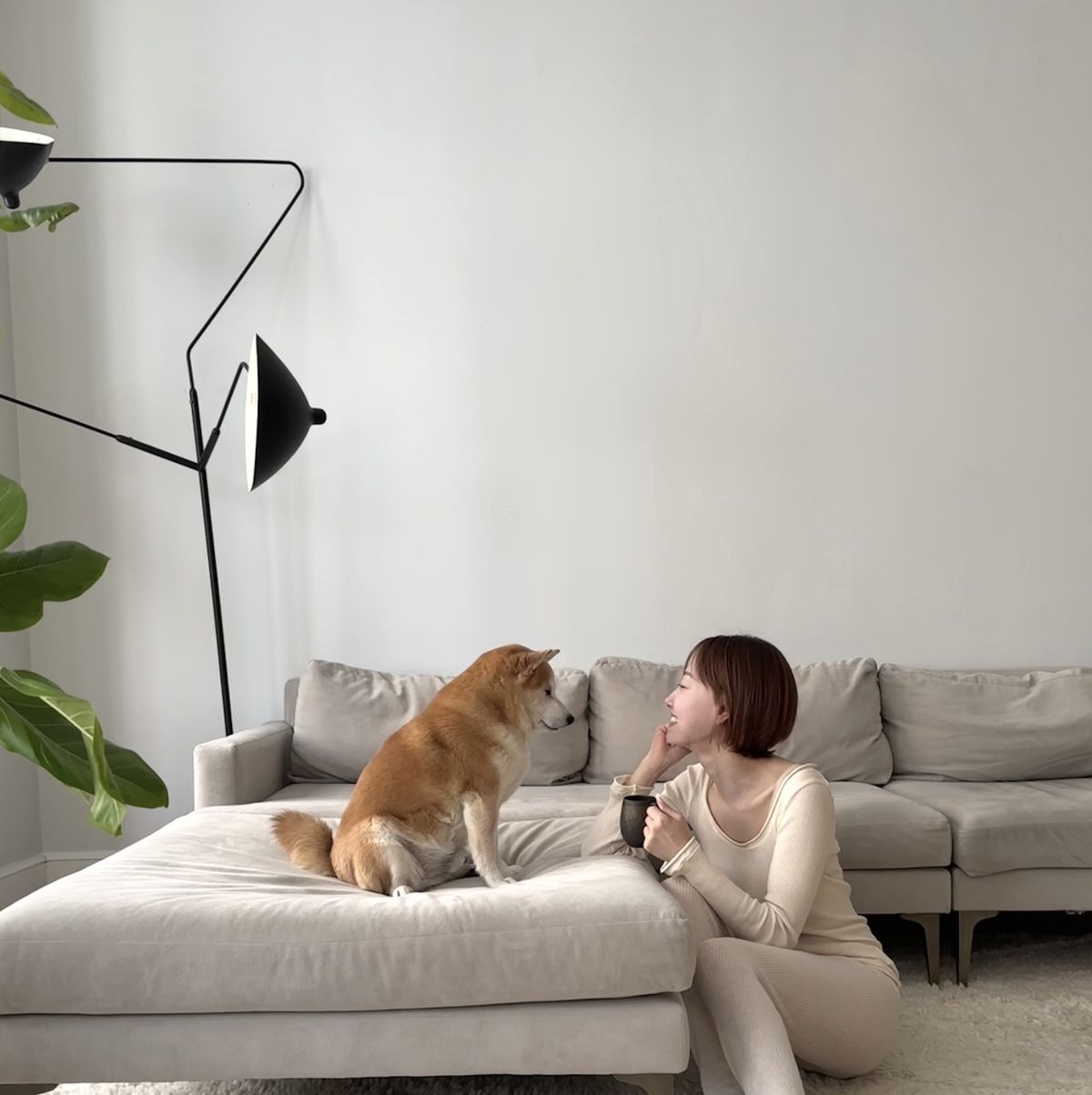 a person sitting on a couch with a dog