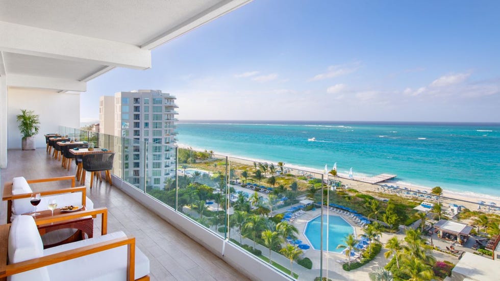 balcony view overlooking a beach and pool