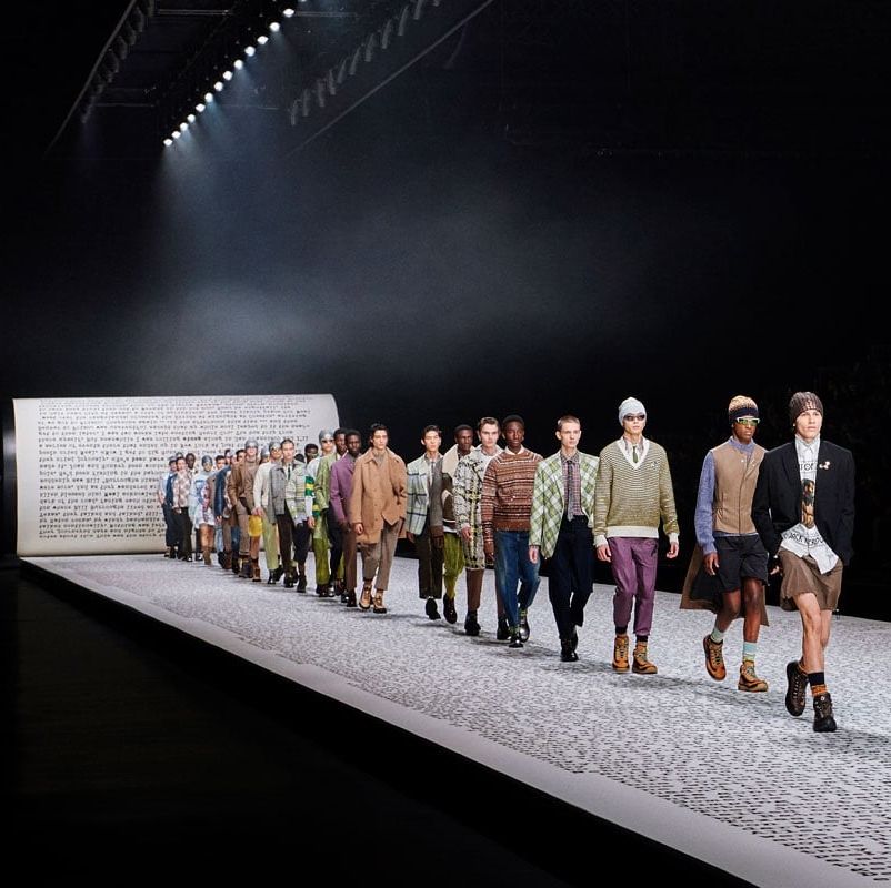 a group of people walking on a runway