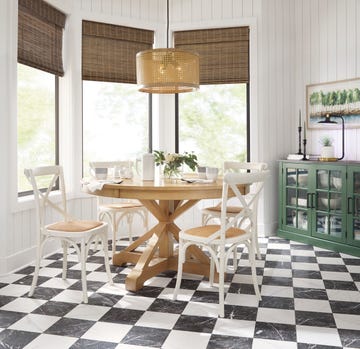 a wood kitchen table and white chairs in a room with a checkerboard floor