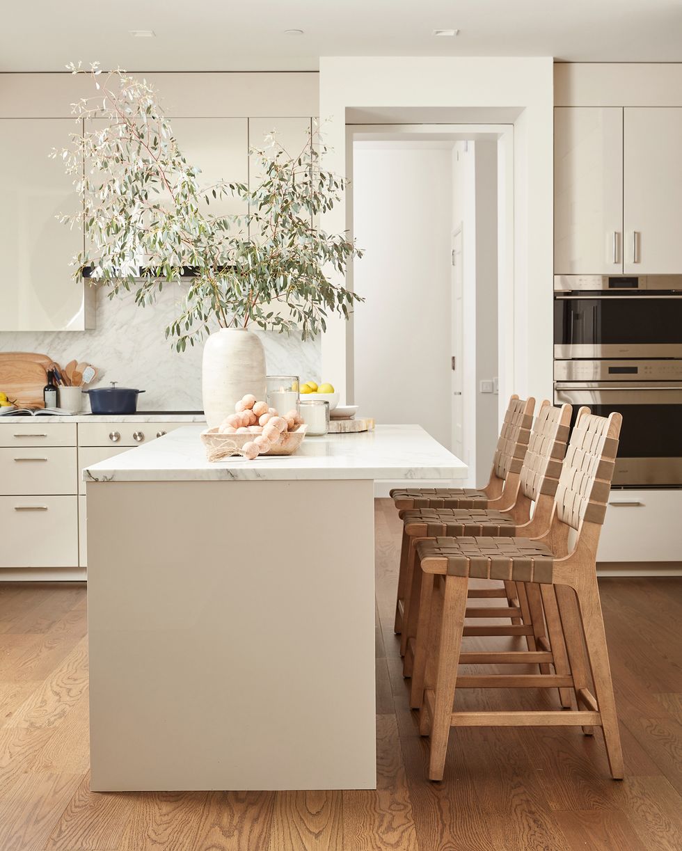 ayesha curry white kitchen with natural wood stools